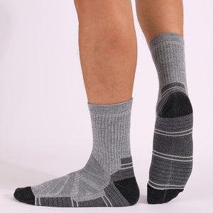 Men wearing gray and black merino wool padded hiking socks showing supportive fit for outdoor trekking
