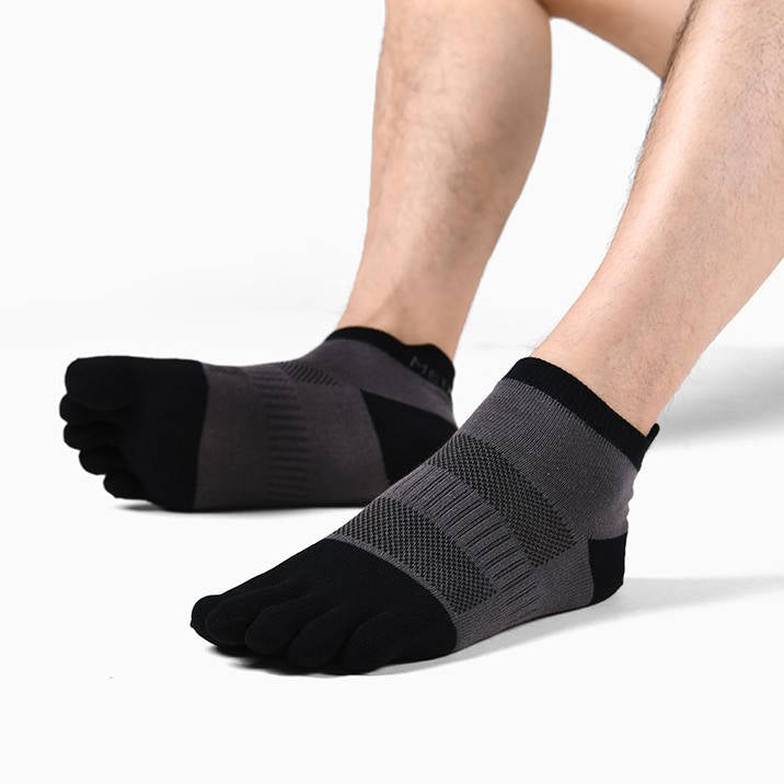 A person wearing black and gray toe socks with reinforced heel design.