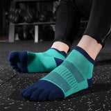 Person exercising in a gym with teal and navy toe socks.
