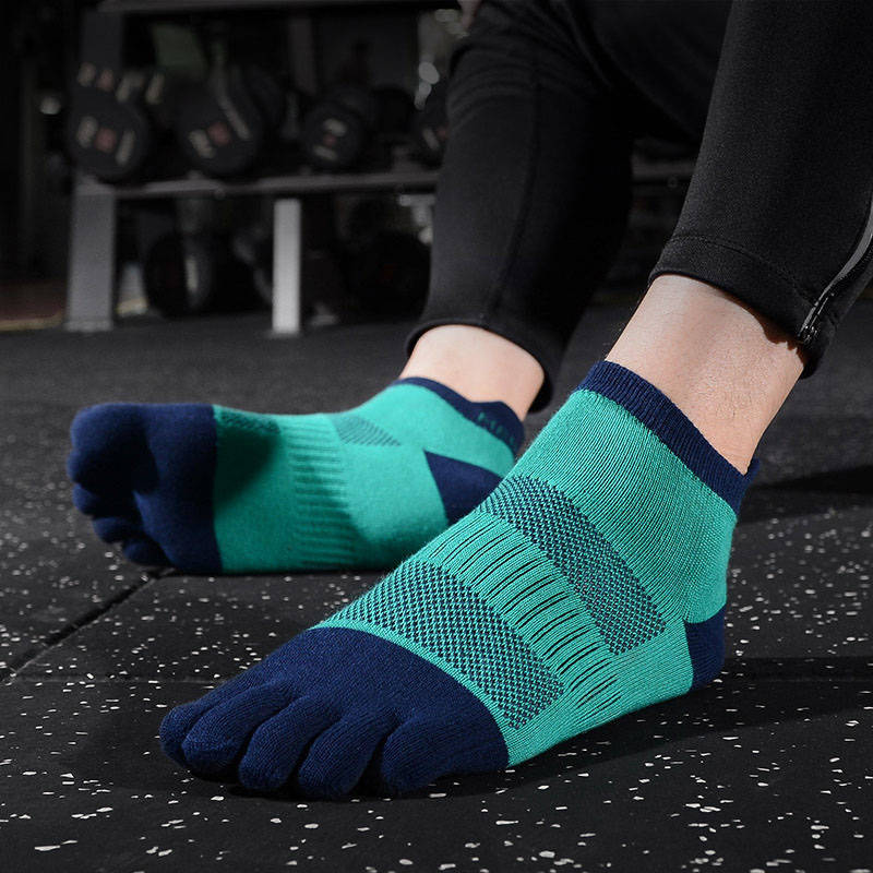 Person exercising in a gym with teal and navy toe socks.